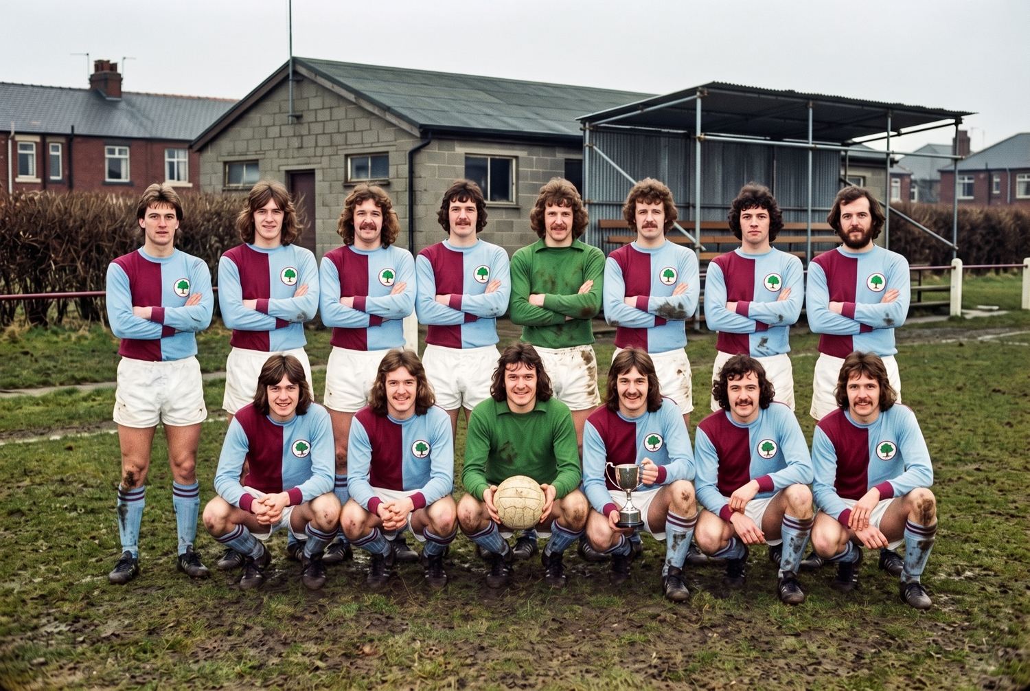 An amateur football team of thirteen posed in two rows on the same pitch in 1998, in baggier kit in the same claret and pale blue halves, one player holding a small trophy.