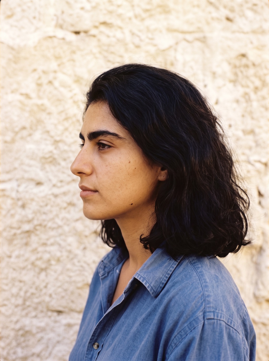 Rosa Marchetti seen from the side against the same backdrop.