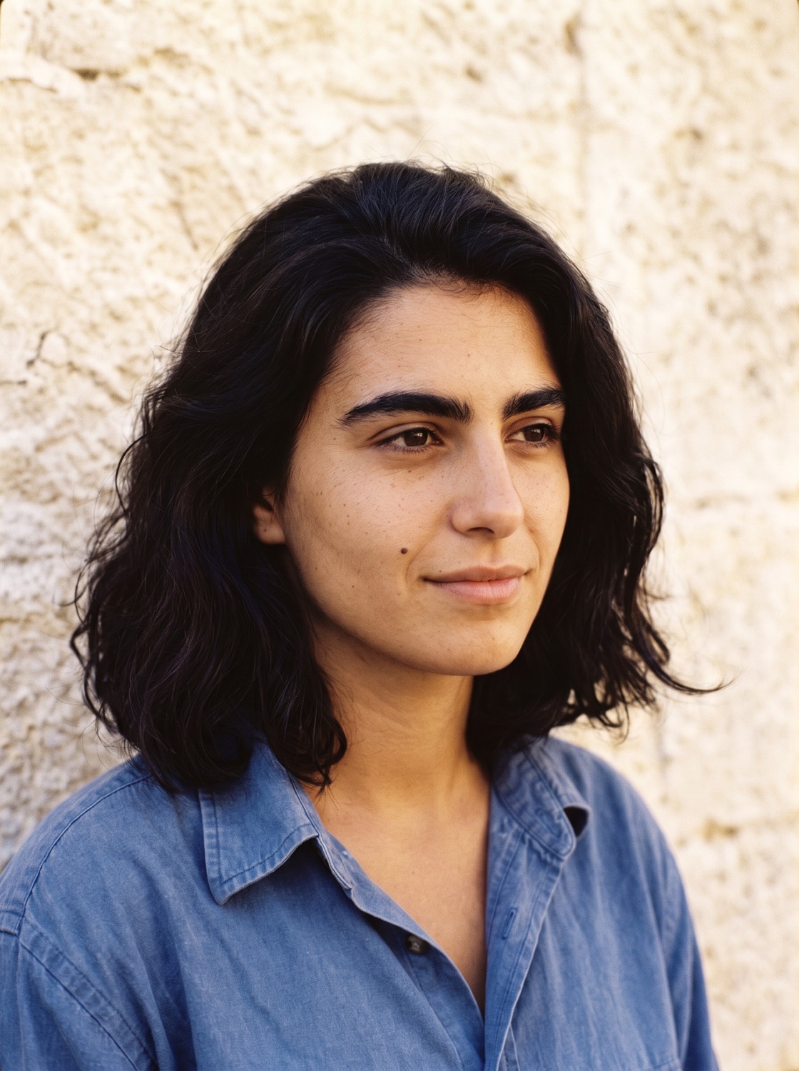 Rosa Marchetti turned part way from the camera against the same backdrop.